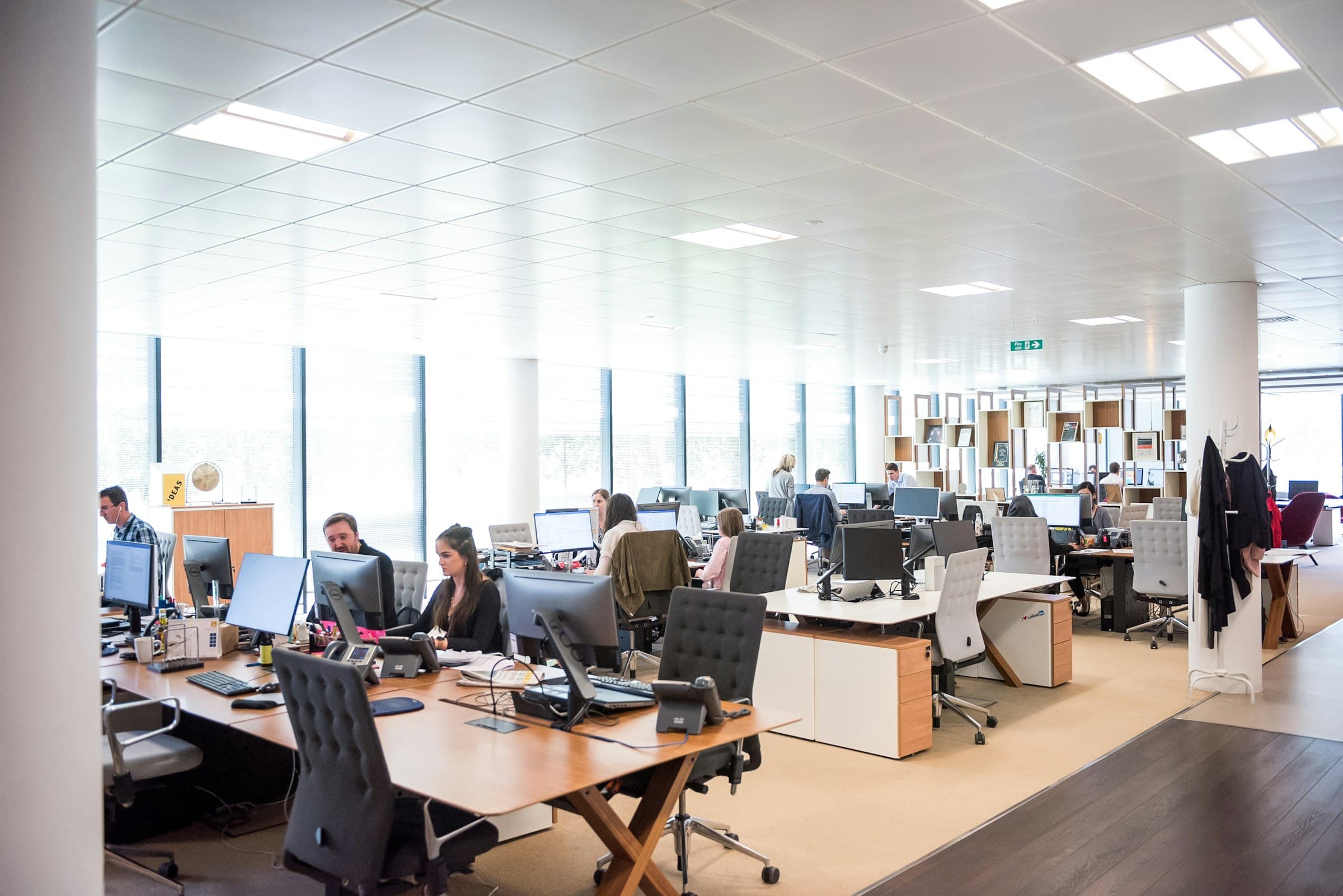 A bright open-plan office with people working at their desks